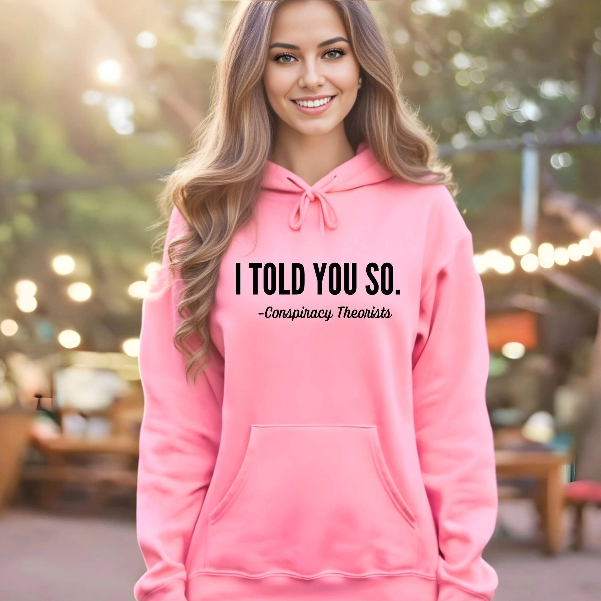 Woman wearing a ink hoodie with text 'I TOLD YOU SO. - Conspiracy Theorists'