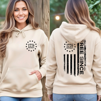 Woman wearing a beige hoodie with '1776 Patriot' text on the front and 'Free Since' design on the back.