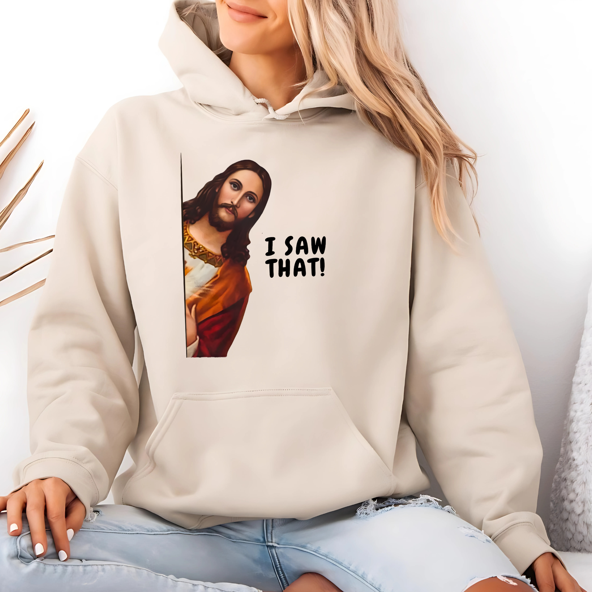 Woman wearing I Saw That funny Jesus graphic hoodie in cream
