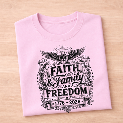 Pink t-shirt with 'Faith & Family & Freedom' text on a wooden surface