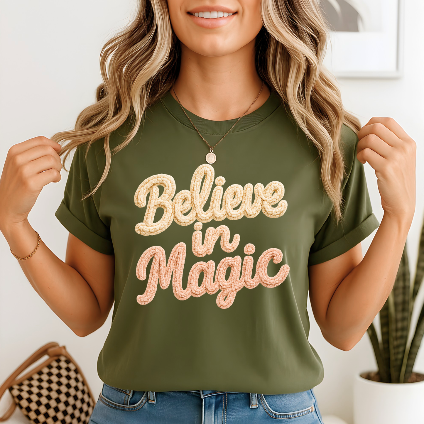 Green unisex t-shirt with Believe in Magic faux crochet textured print, holiday Christmas graphic tee for women and youth, Black Friday seasonal shirt.