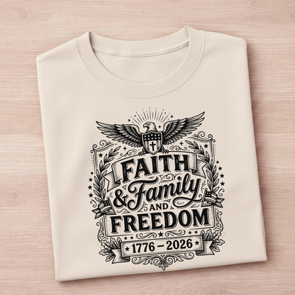 Folded sand colored patriotic t-shirt with black graphic design on a light pink background