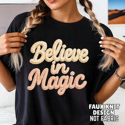 Close-up black unisex shirt showing Believe in Magic faux crochet textured print, detailed holiday yarn-look graphic, Black Friday apparel.