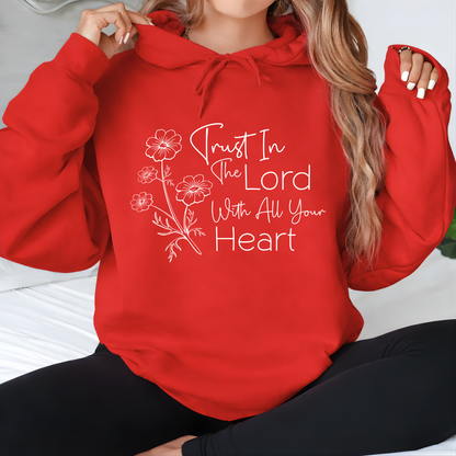 Person wearing a red hoodie with a motivational quote and floral design.
