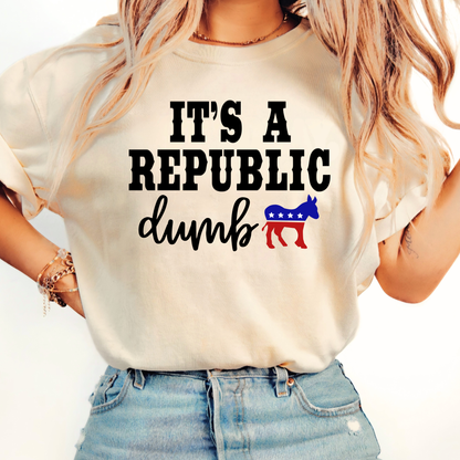 Woman wearing sand color pullover hoodie with “It’s a Republic Dumb” design outdoors