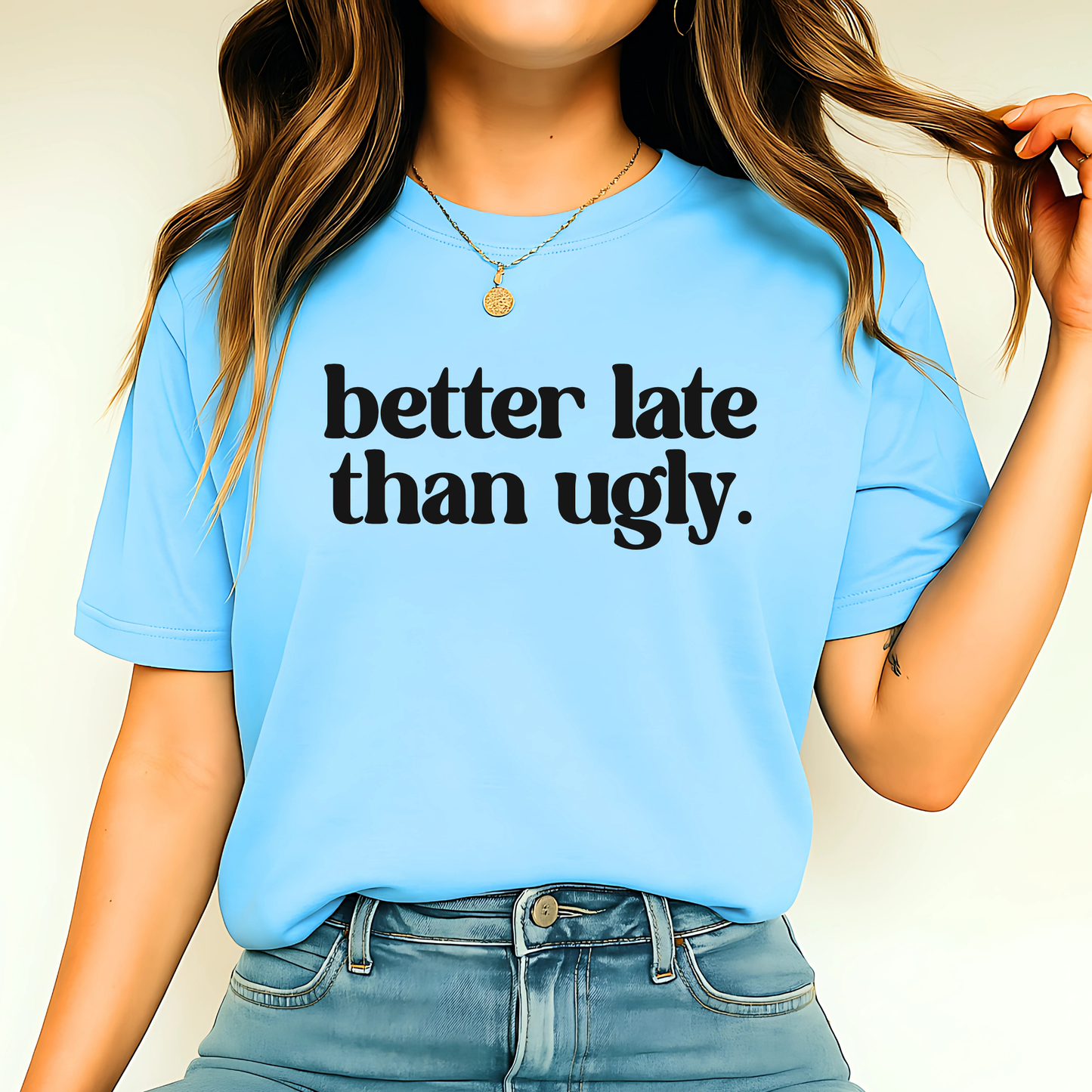 Person wearing a blue t-shirt with 'better late than ugly' text.