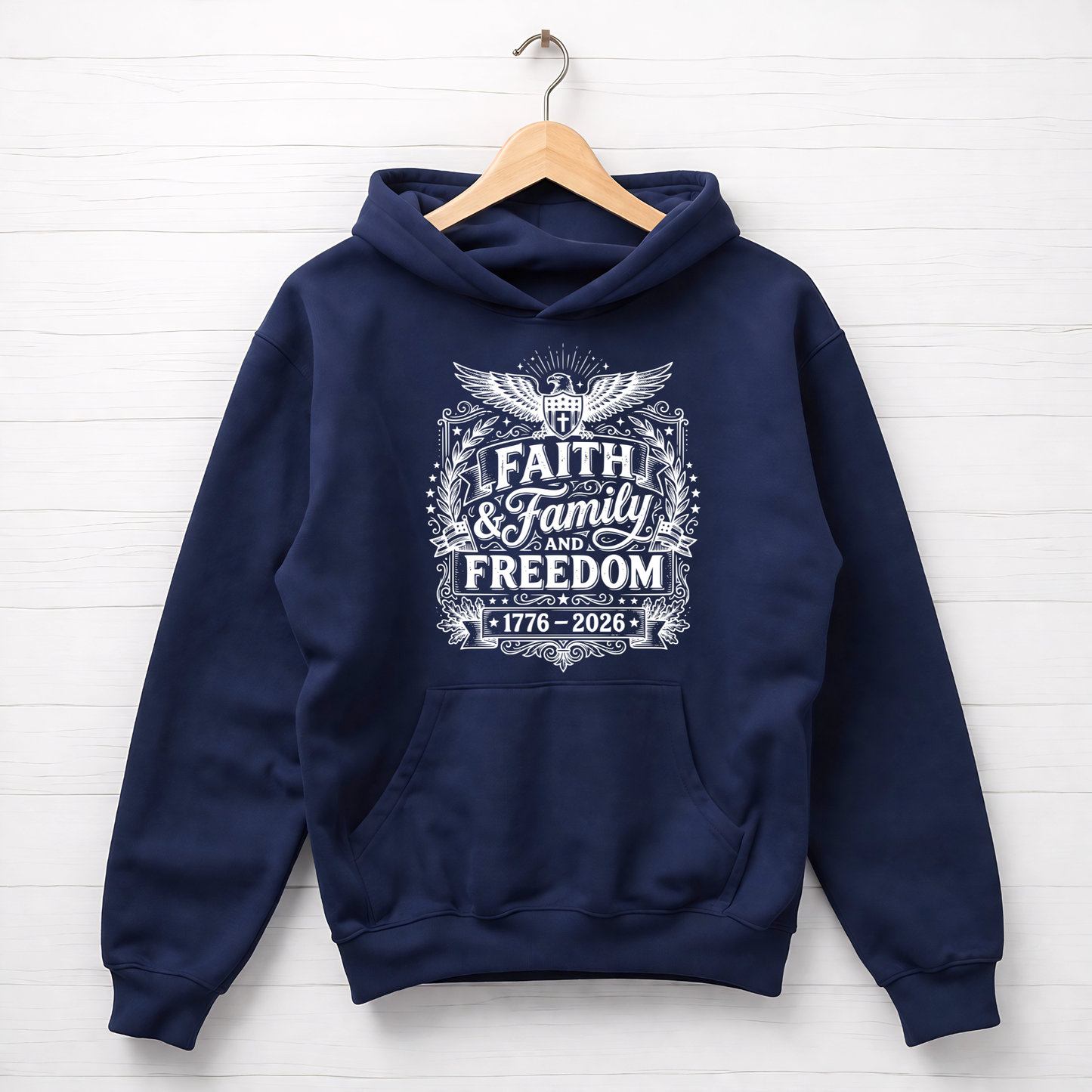 Navy blue hoodie with 'Faith & Family & Freedom' text on a wooden hanger against a white background