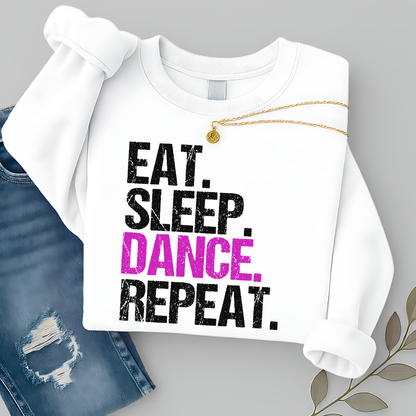 White sweatshirt with 'Eat. Sleep. Dance. Repeat.' text on a gray background