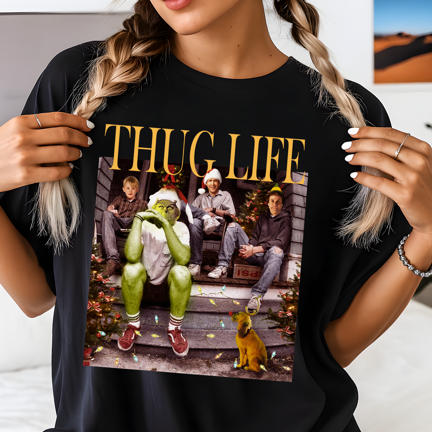 Person wearing a black t-shirt with a graphic design featuring a green character and text.