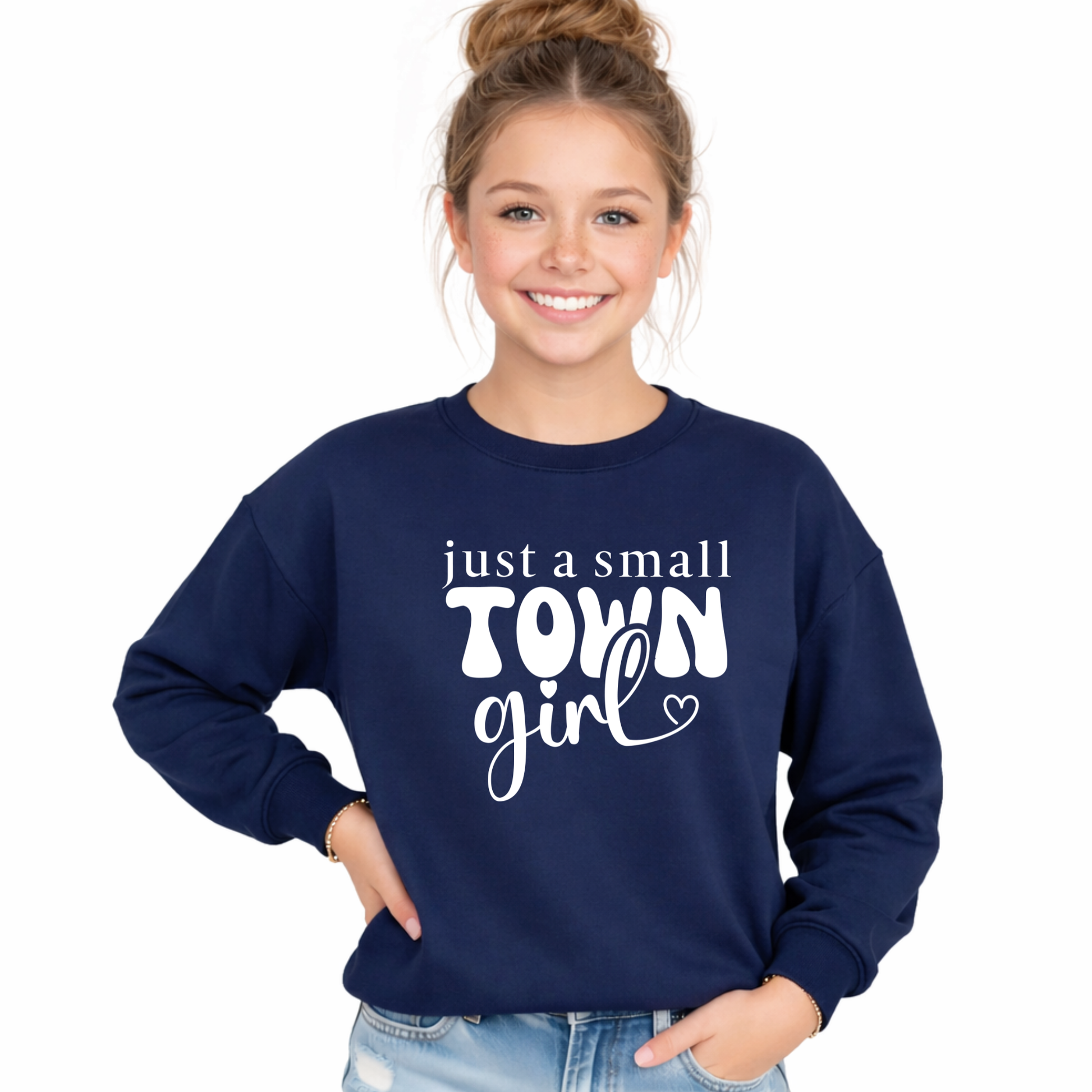 Tween girl wearing a navy blue sweatshirt with 'just a small town girl' text on a white background