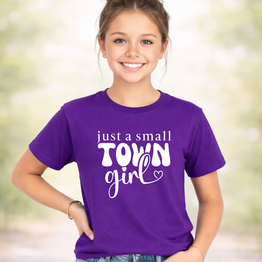 Youth girl wearing purple t-shirt with “just a small town girl” graphic design, cute trendy kids shirt, casual outfit