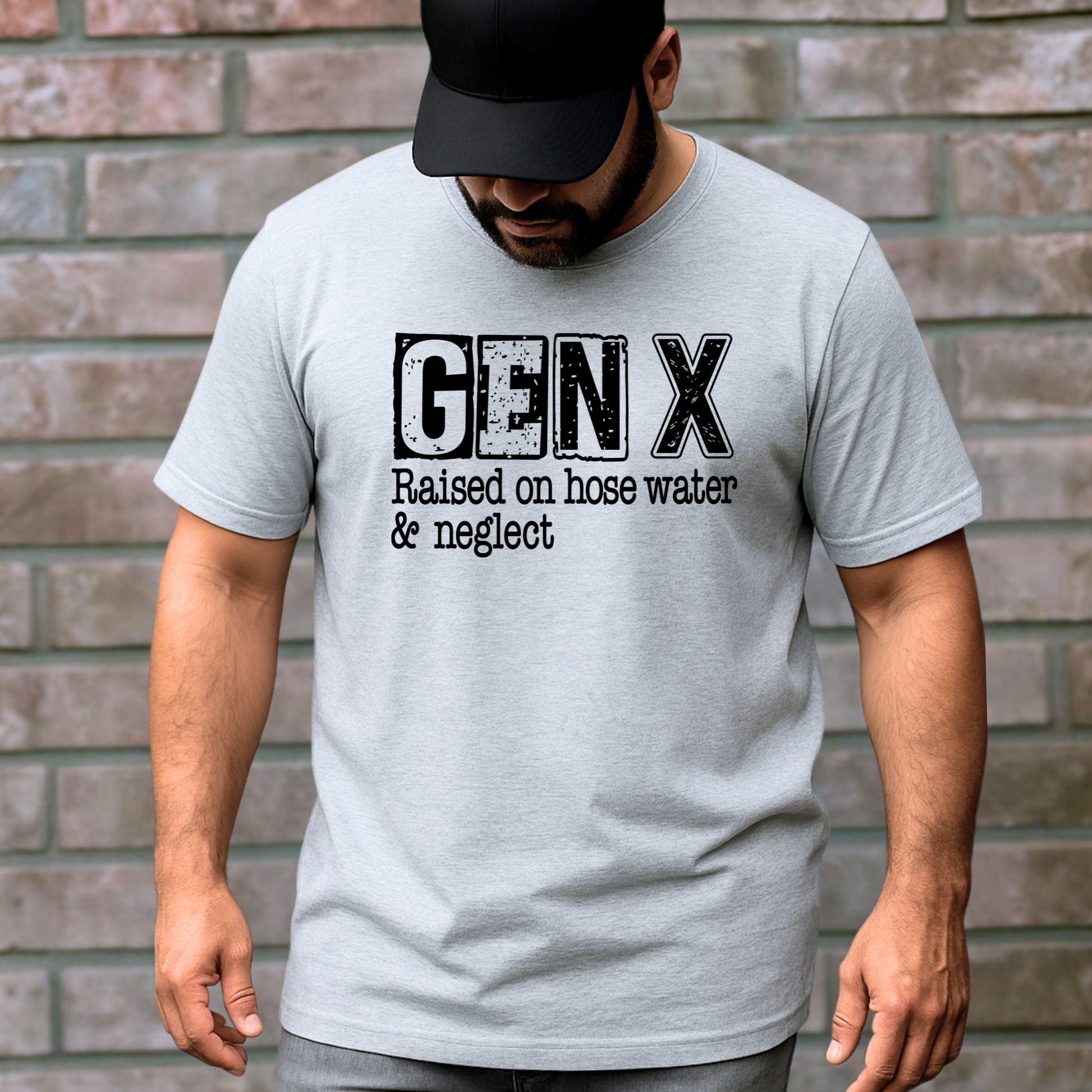 Man wearing a gray t-shirt with 'GEN X Raised on hose water & neglect' text against a brick wall.