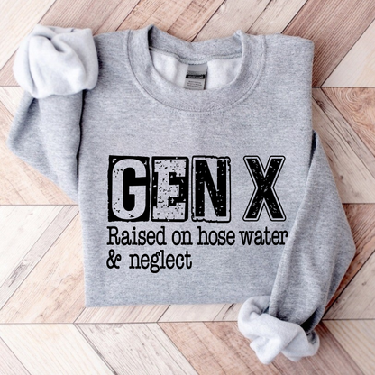 Gray sweatshirt with 'GEN X Raised on hose water & neglect' text on a wooden floor.