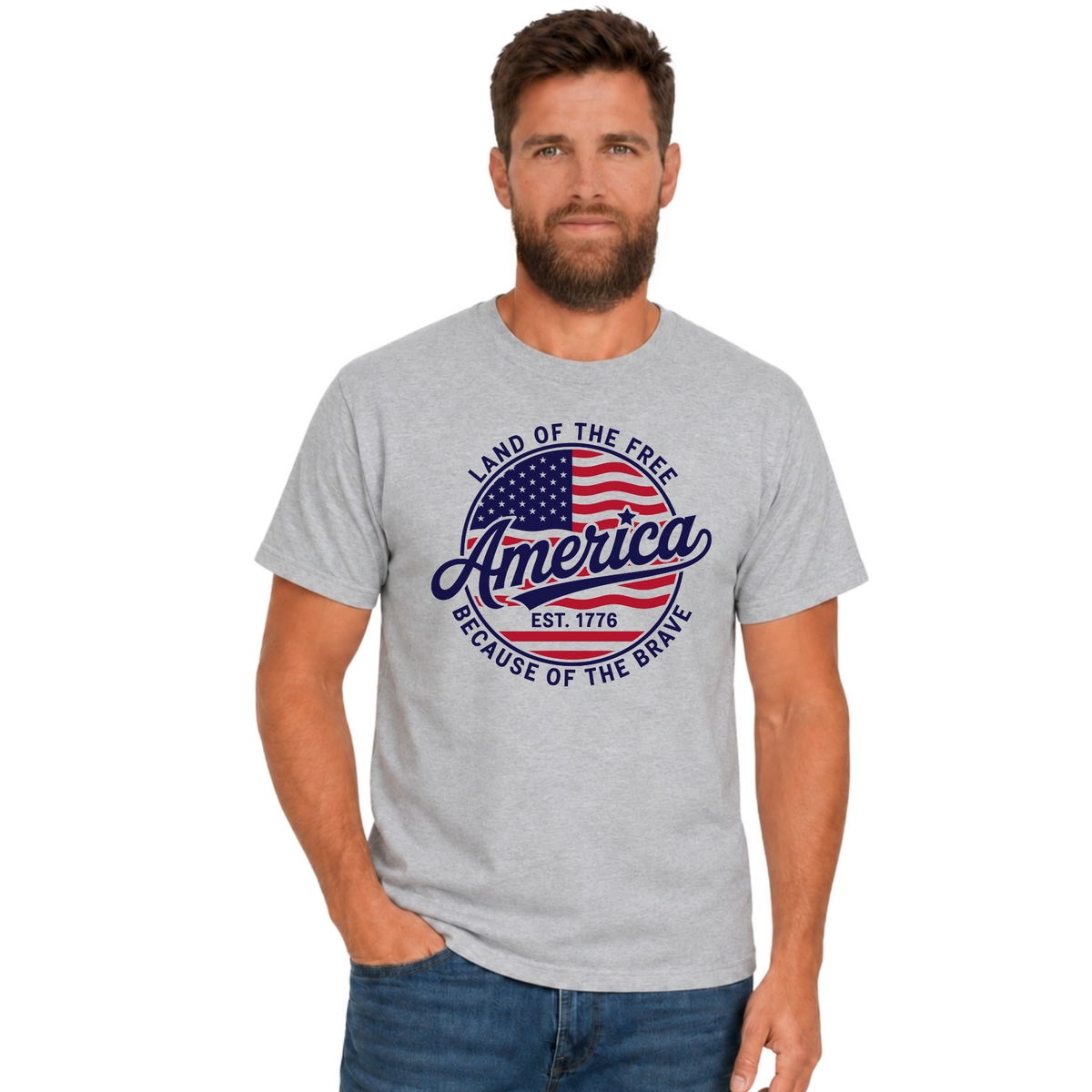 Male model wearing a sports gray T-shirt with a red, white, and blue circular America graphic reading Land of the Free, Est. 1776, and Because of the Brave.