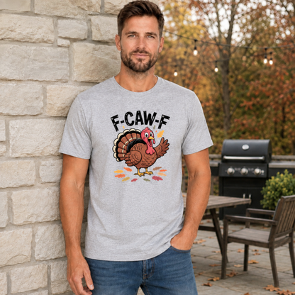 Man wearing a sports gray T-shirt with a colorful F-CAW-F turkey graphic in a fall patio setting.
