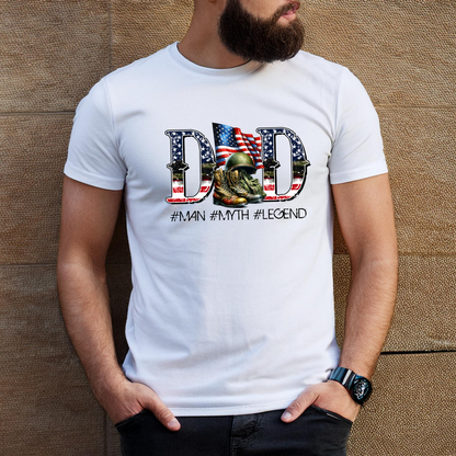 White shirt featuring DAD with flag fill and helmet/boots graphic – tribute to military fathers

