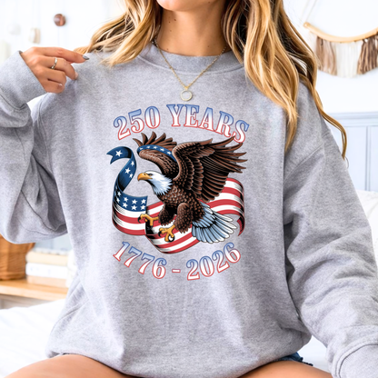 Person wearing a gray sweatshirt with an eagle and American flag design celebrating 250 years from 1776 to 2026.