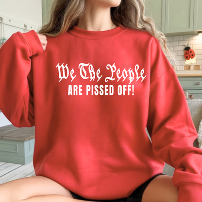 Woman wearing a red "We The People are Pissed off" sweatshirt. 