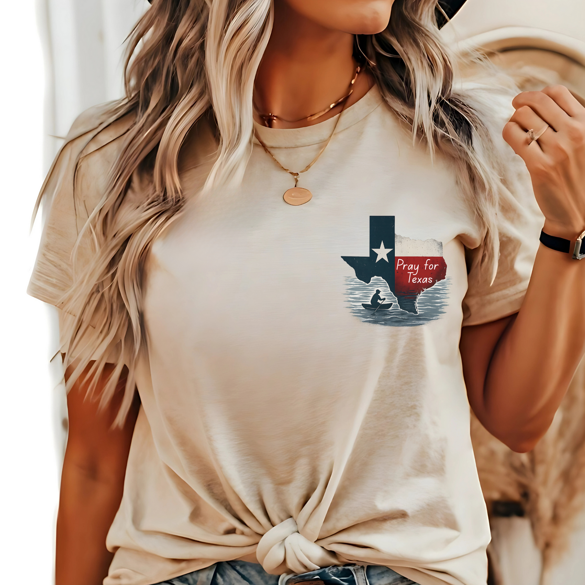 Person wearing a beige t-shirt with a graphic design of Texas and a red heart.