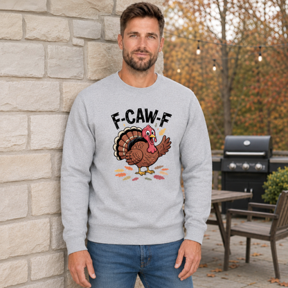Man wearing a sports gray crewneck sweatshirt with a colorful F-CAW-F turkey graphic in a fall patio setting.