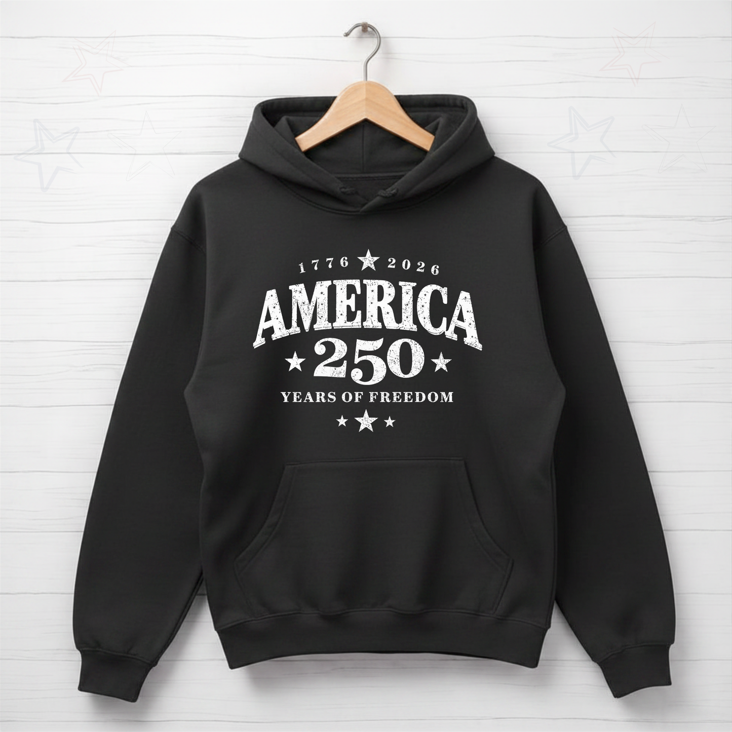 Black hoodie with 'America 250 Years of Freedom' text on a white brick wall background