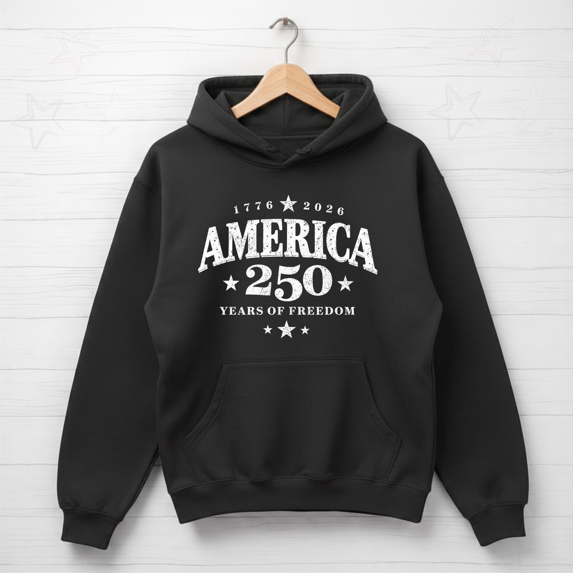 Black hoodie with 'America 250 Years of Freedom' text on a white brick wall background