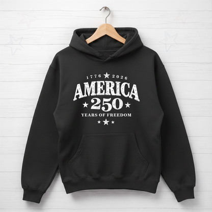 Black hoodie with 'America 250 Years of Freedom' text on a white brick wall background