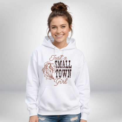 Woman wearing a white hoodie with the “Just a Small Town Girl” western cowgirl graphic, shown against a clean light studio background.