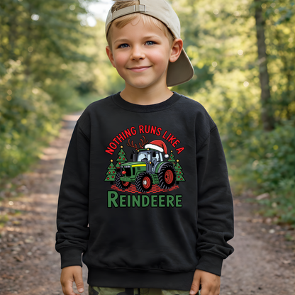 Child wearing a black sweatshirt with a Christmas design in a forest setting