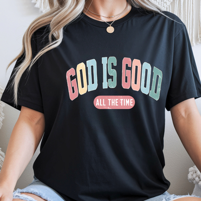 Person wearing a black t-shirt with 'GOD IS GOOD ALL THE TIME' text in colorful letters.