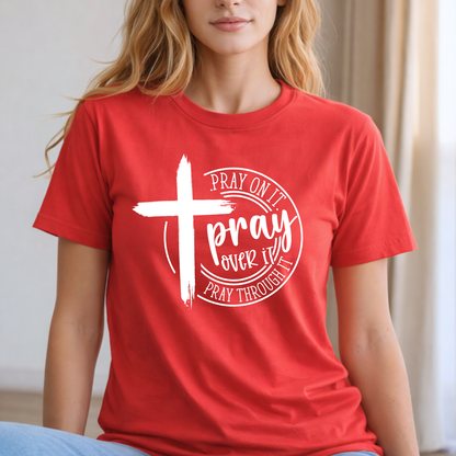 wOMAN wearing a red t-shirt with a white cross and text design.