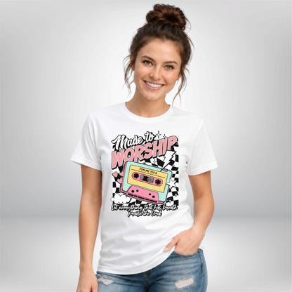 Woman wearing a white Made to Worship T-shirt with a retro cassette graphic on a studio background.