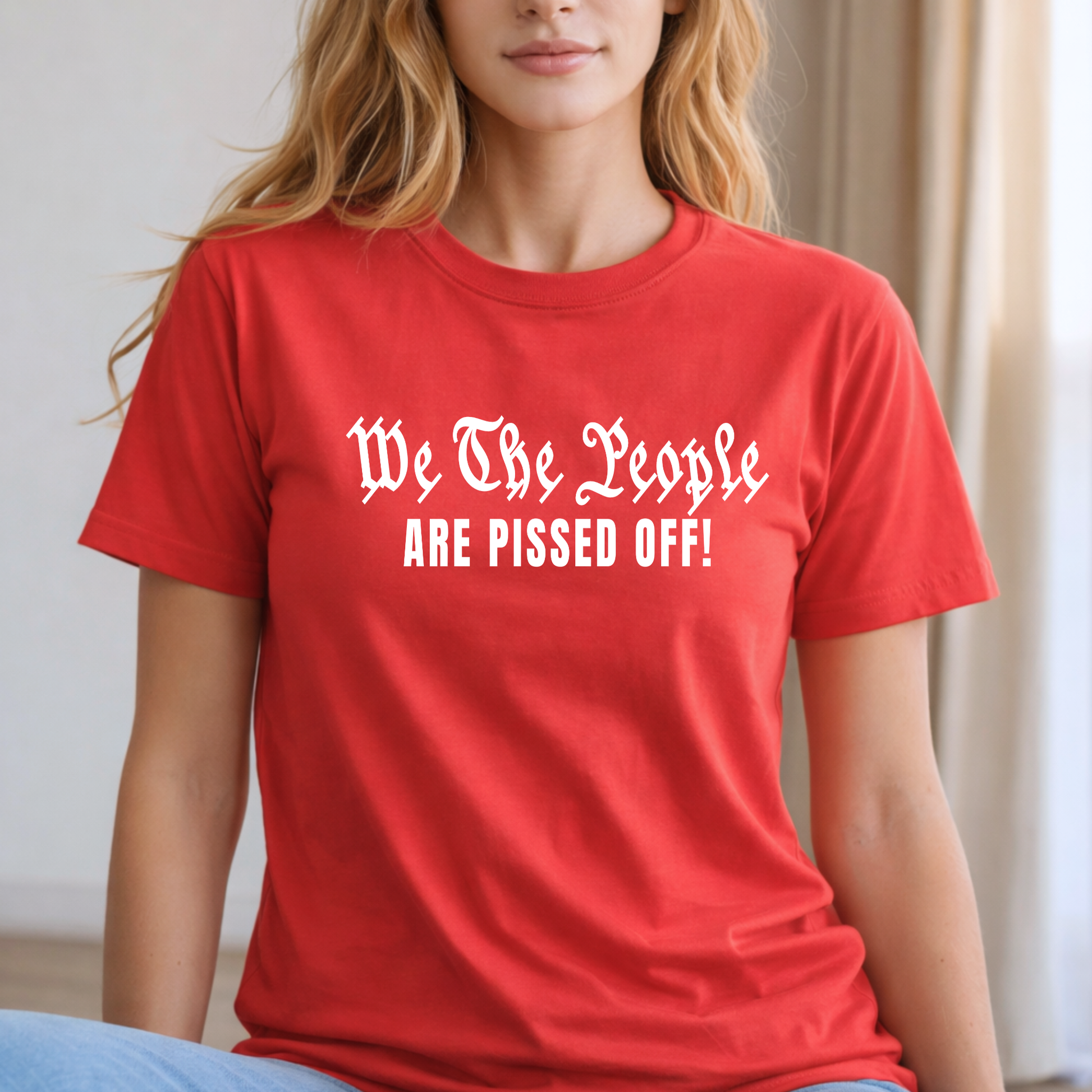 Person wearing a red t-shirt with text 'We The People ARE PISSED OFF!'