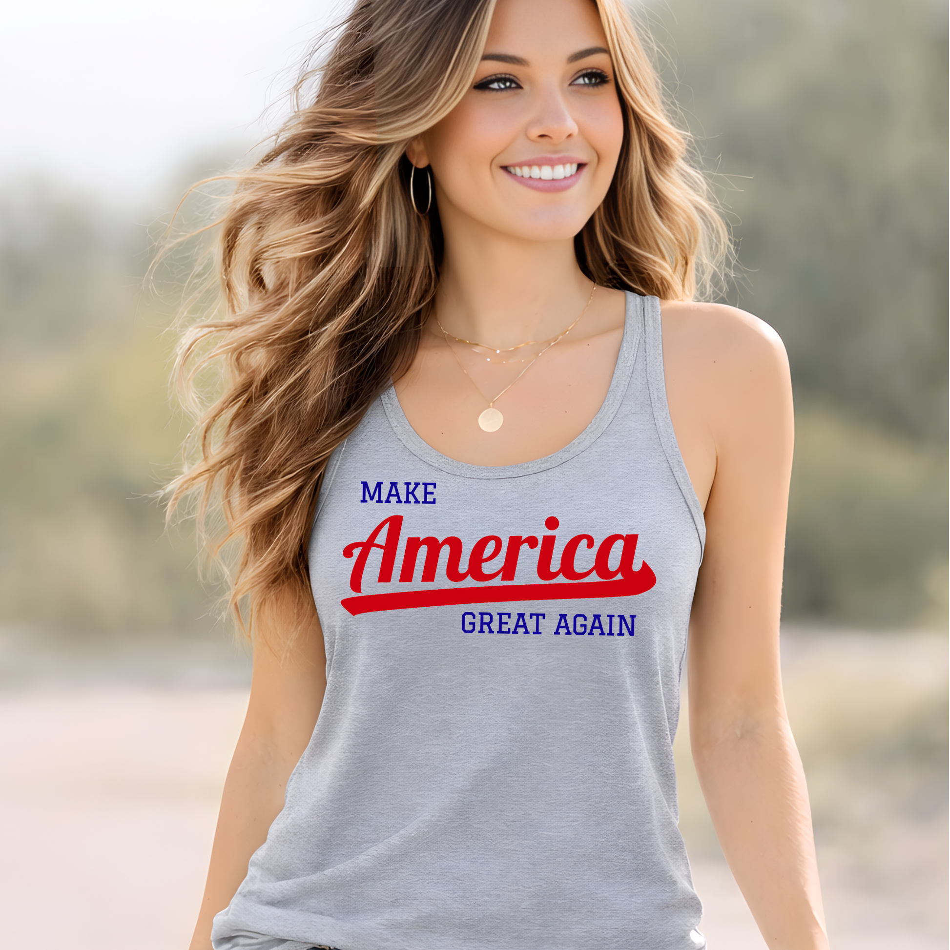 Sports gray women’s racerback tank top flat lay with Make America Great Again patriotic graphic, styled with sunglasses, sandals, and American flag