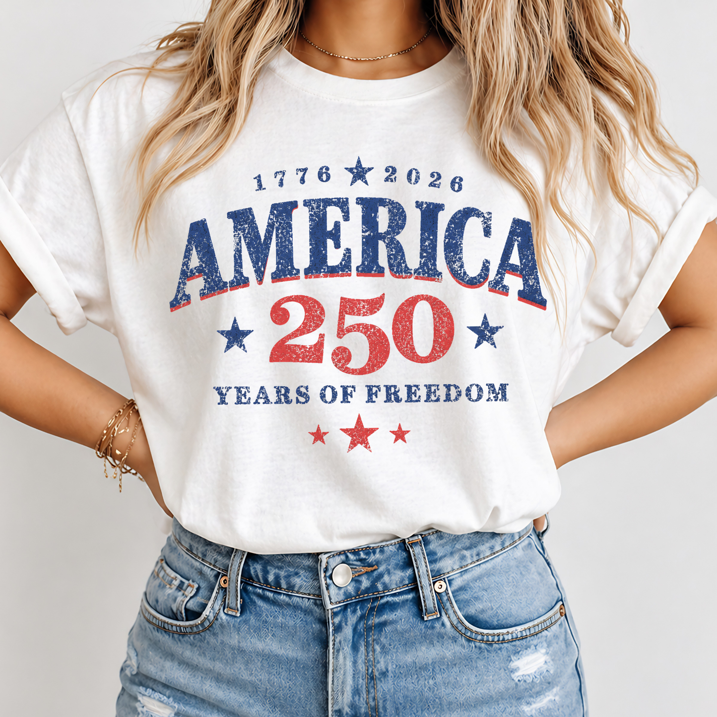 Person wearing a white t-shirt with 'America 250 Years of Freedom' text on a plain background