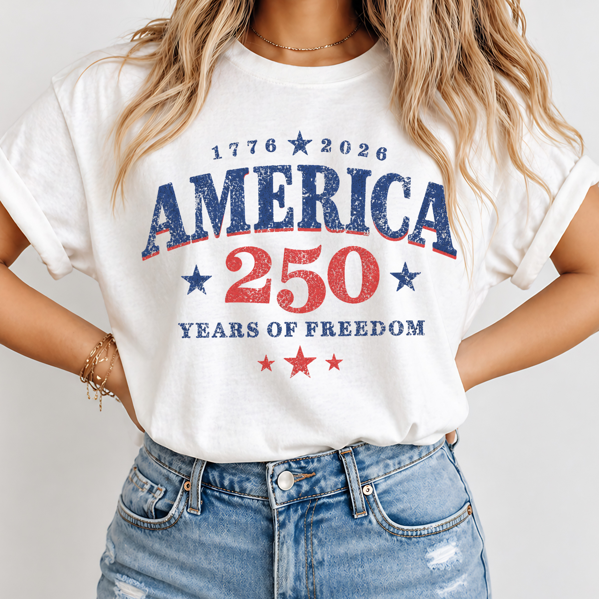Person wearing a white t-shirt with 'America 250 Years of Freedom' text on a plain background