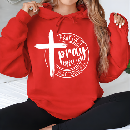 Woman wearing a red hoodie with a cross and text design.
