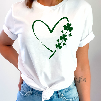 A woman wearing a white T-shirt with a minimalist green heart and shamrock design, perfect for St. Patrick’s Day celebrations.