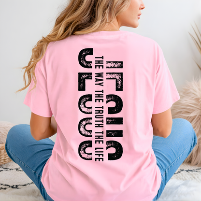 Woman wearing pink Christian t-shirt with small front cross and bold vertical “Jesus The Way The Truth The Life” back design