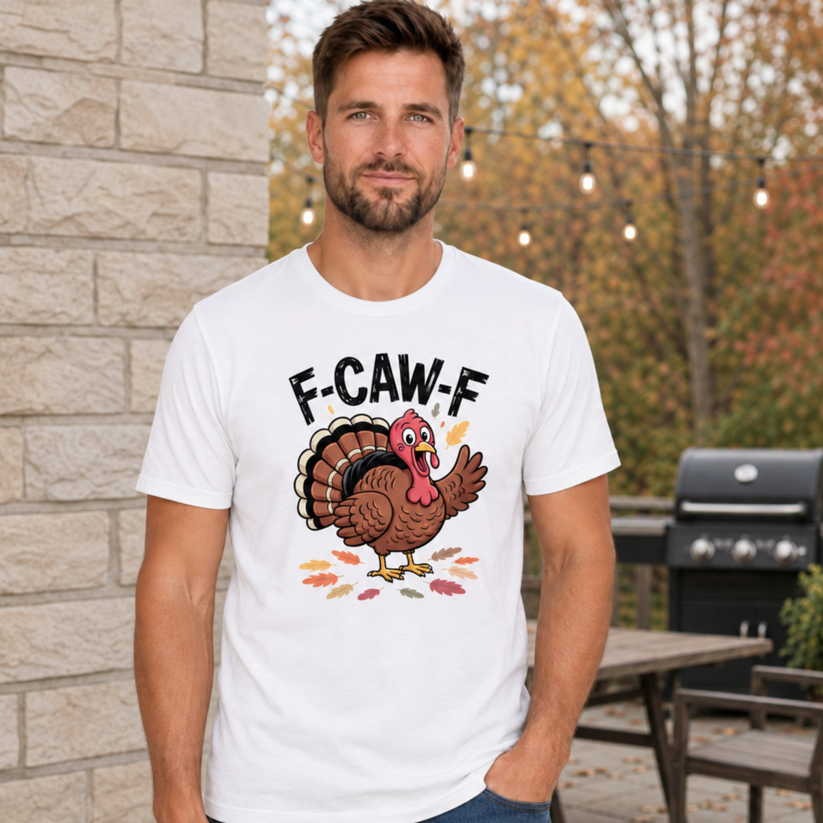 Man wearing a white T-shirt with a colorful F-CAW-F turkey graphic in a fall patio setting.