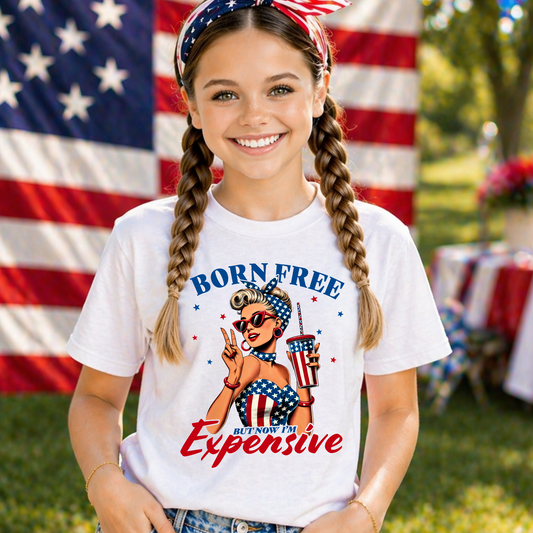 Girl wearing a t-shirt with a graphic design born free but now im expensive at a 4th of july party.
