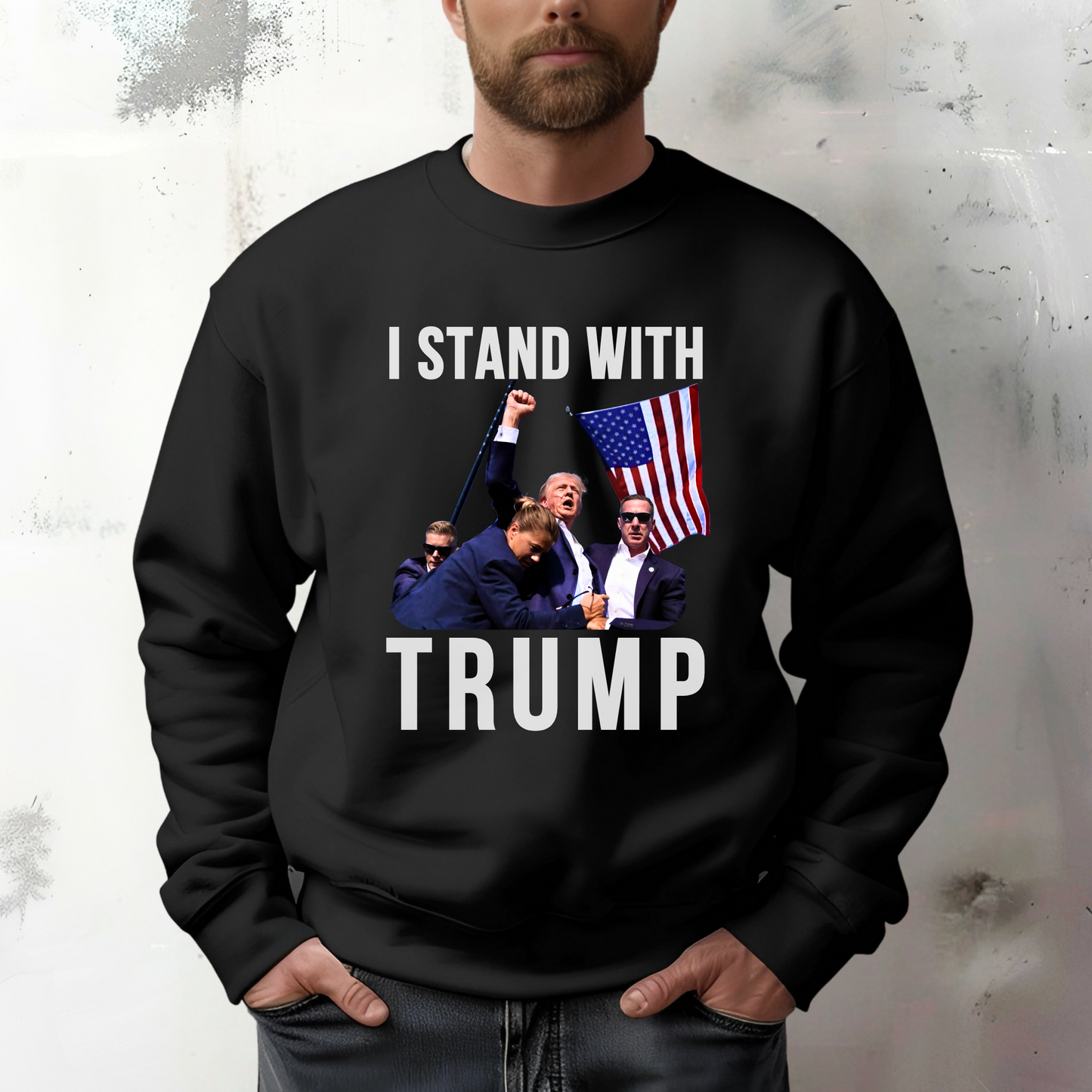 Man wearing “I Stand With Trump” black sweatshirt with bold flag and Trump scene – patriotic men’s pullover