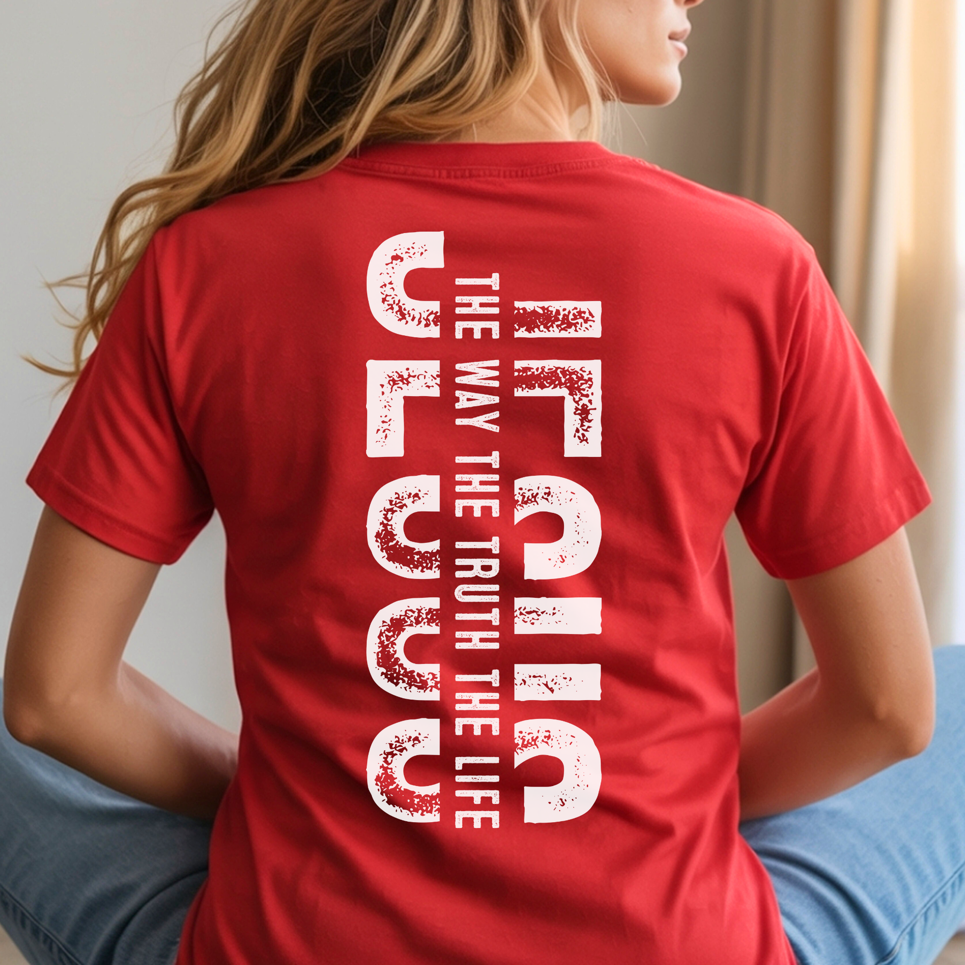 Woman wearing red Christian t-shirt with minimalist front cross and large vertical Jesus faith design on back