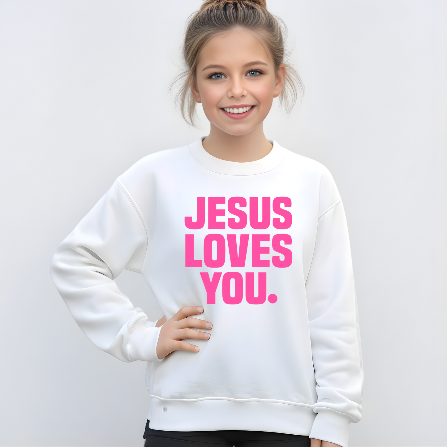 Tween Girl wearing a white sweatshirt with 'Jesus Loves You' in pink text on a plain background