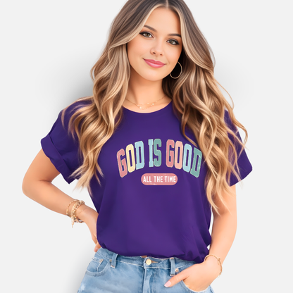 Woman wearing a purple t-shirt with 'God is Good All the Time' text on a white background