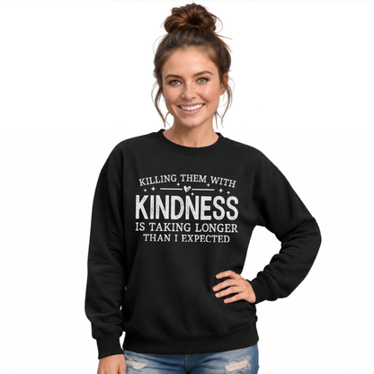 Laughing woman wearing a black Killing Them With Kindness crewneck sweatshirt with white lettering and distressed jeans.