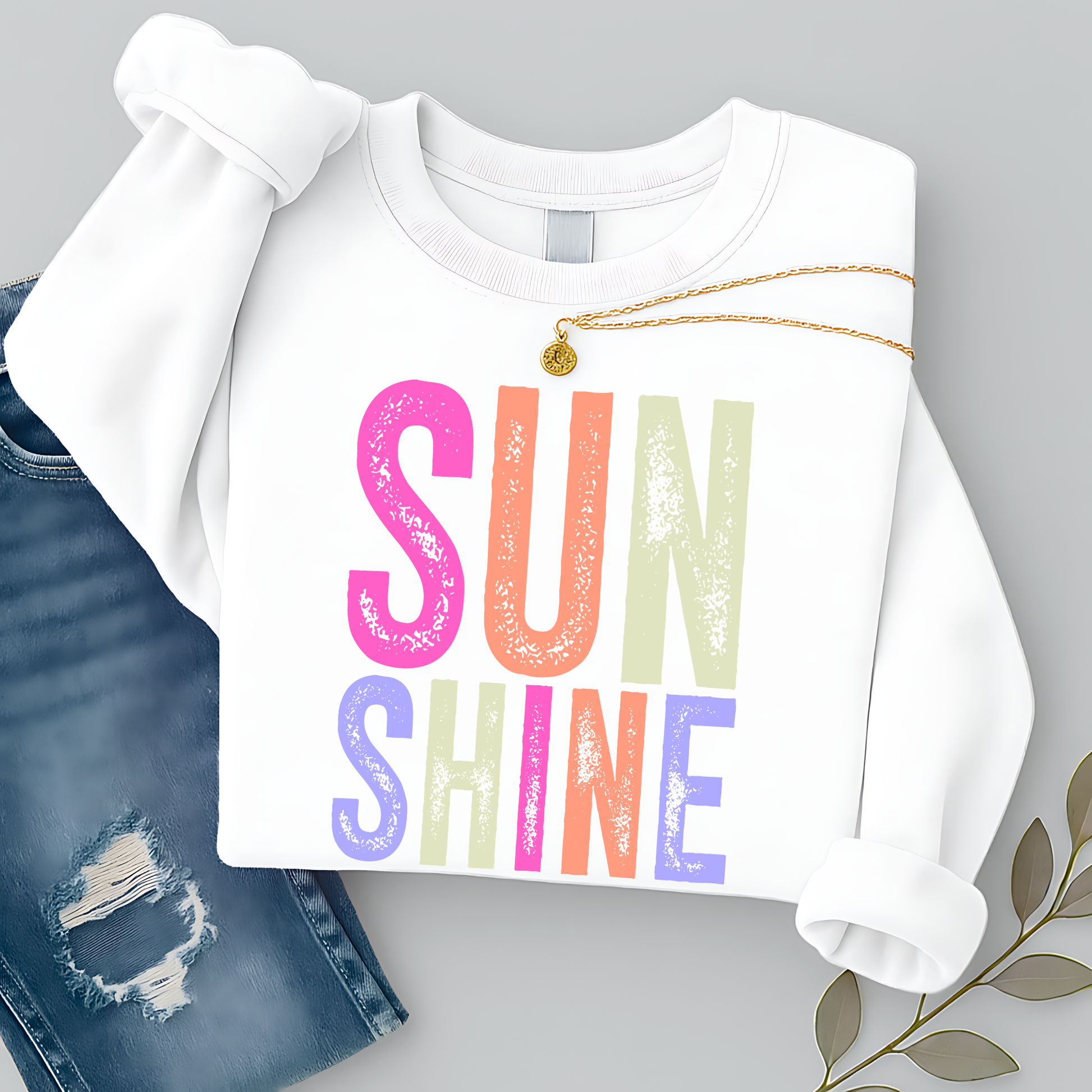 White sweatshirt with 'SUNSHINE' in colorful letters on a gray background