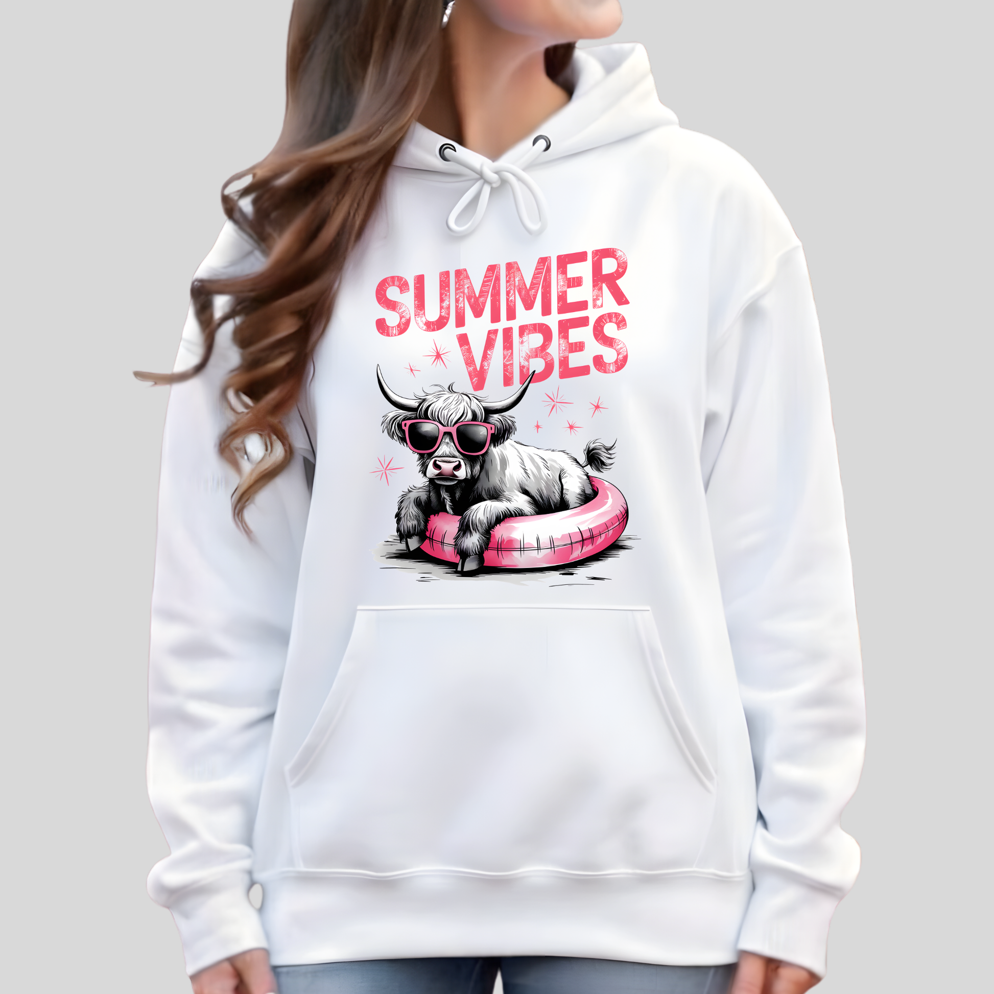 White hoodie with 'Summer Vibes' text and graphic of a cow on a pink floatie, worn by a person.