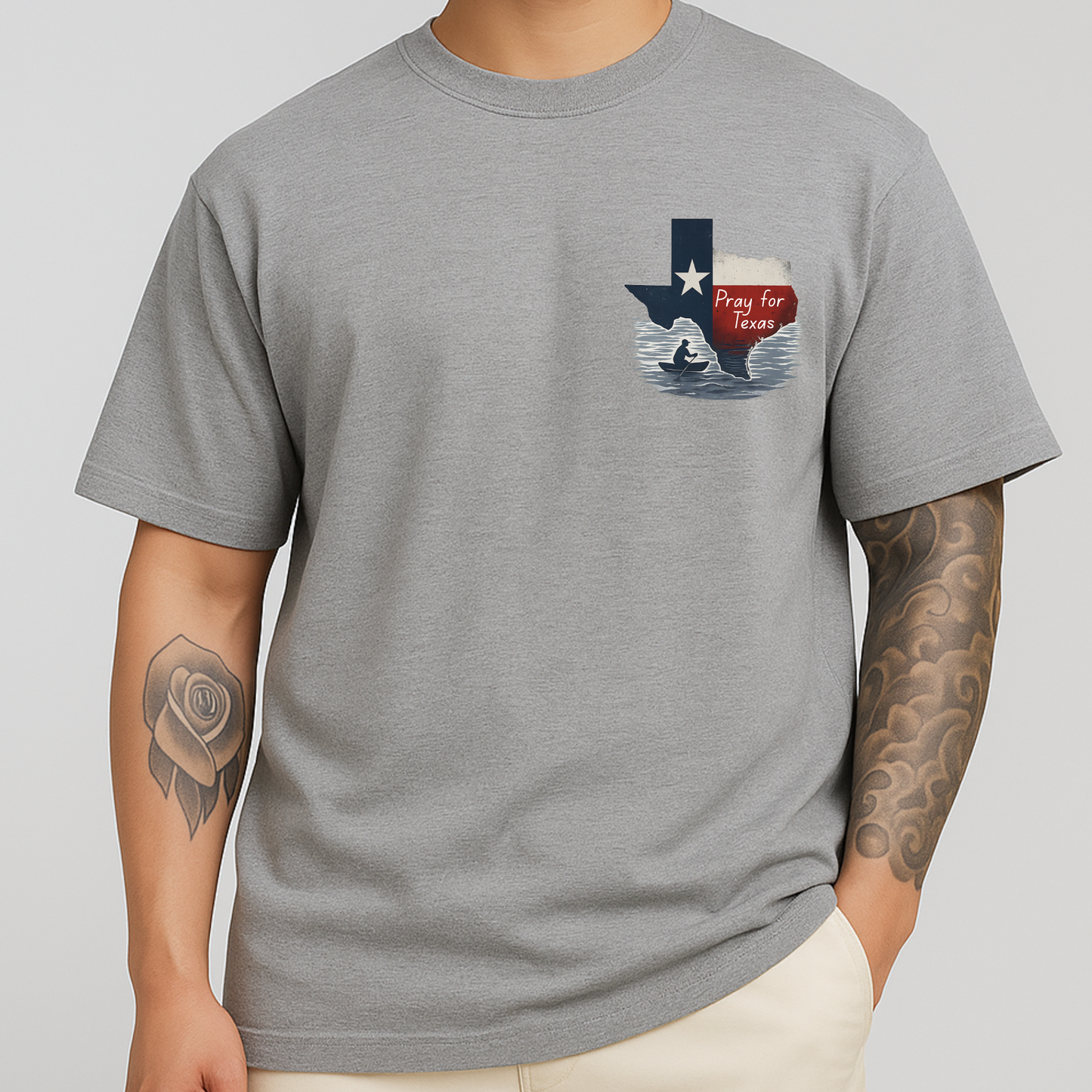 Man wearing gray Pray for Texas shirt featuring Texas state shape, floodwaters, and a silhouette in prayer. Front design only.