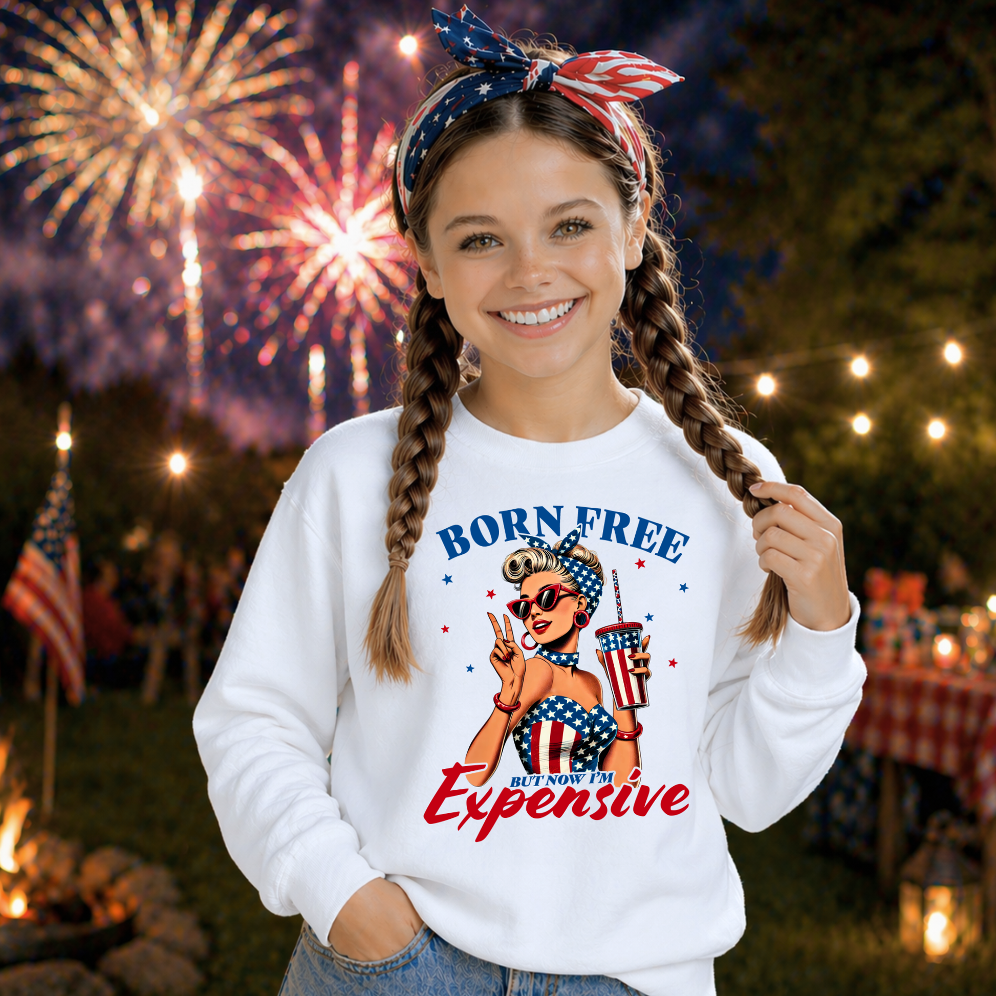 Girl wearing a 'Born Free But Now I'm Expensive' sweatshirt with fireworks in the background